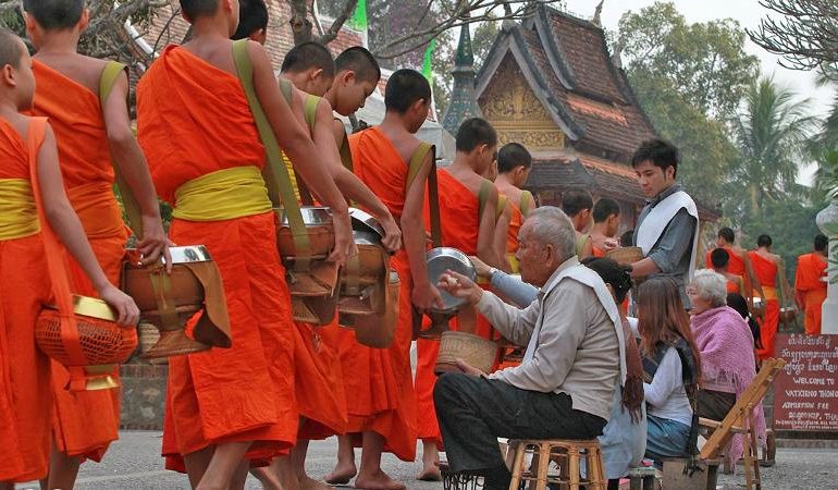 Early morning alms giving in Laos 770x450