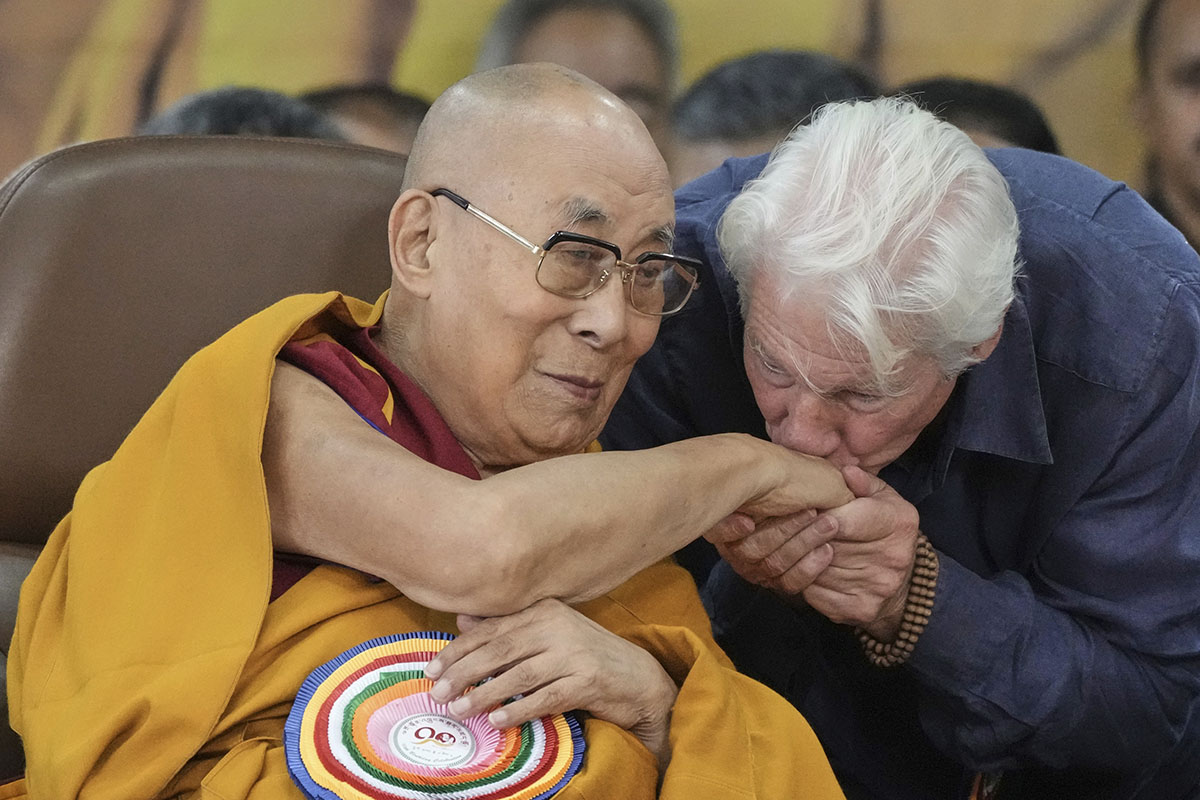 Actor Richard Gere, right, kisses the hand of Tibetan spiritual leader the Dalai Lama at an event celebrating the Dalai Lama's 90th birthday in Dharamshala, India, Sunday, July 6, 2025. (AP Photo/Ashwini Bhatia)