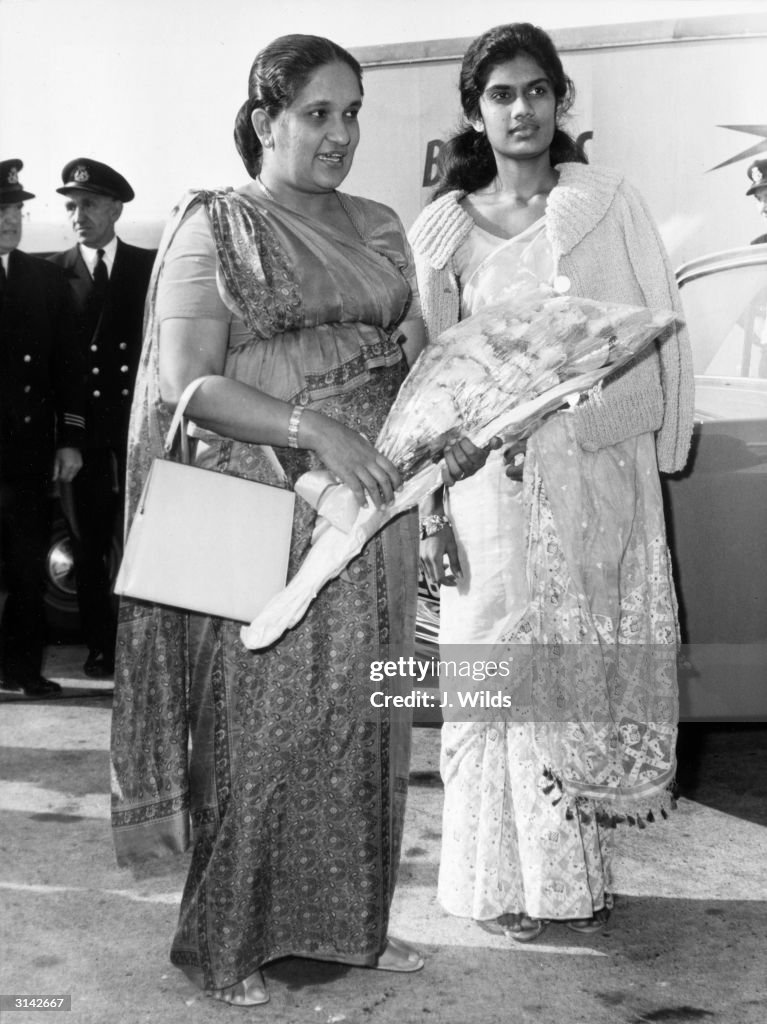 6th July 1964:  Sirimavo Ratwatte Bandaranaike, Prime Minister of Ceylon, (now Sri Lanka), arrives at London Airport with her daughter, Chandrika, to attend the Commonwealth Prime Minister's Conference.  (Photo by J. Wilds/Keystone/Getty Images)